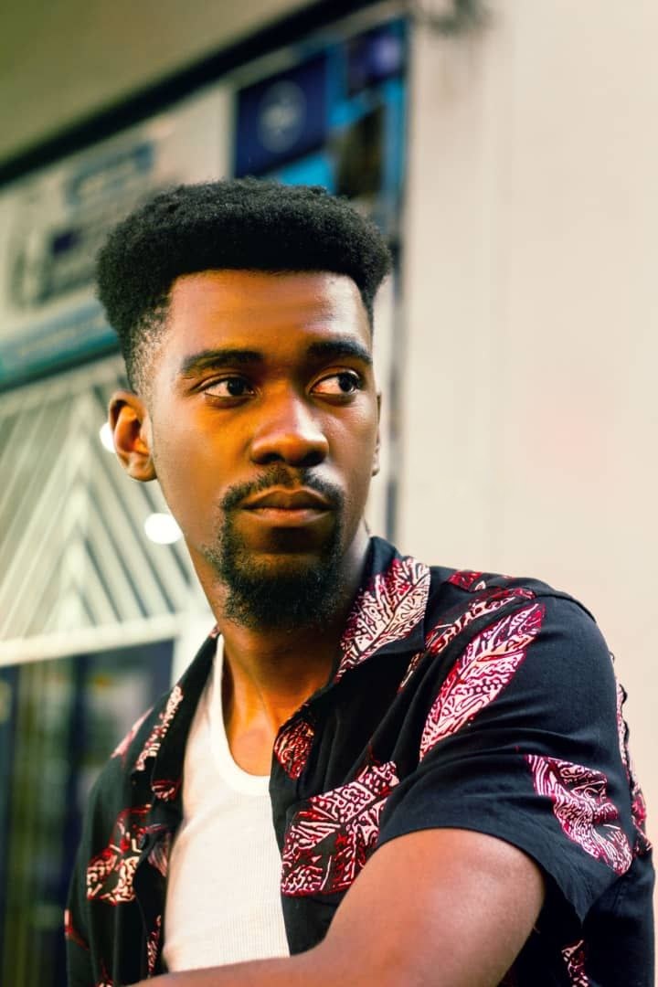 Den Creus in a patterned shirt, looking to the side