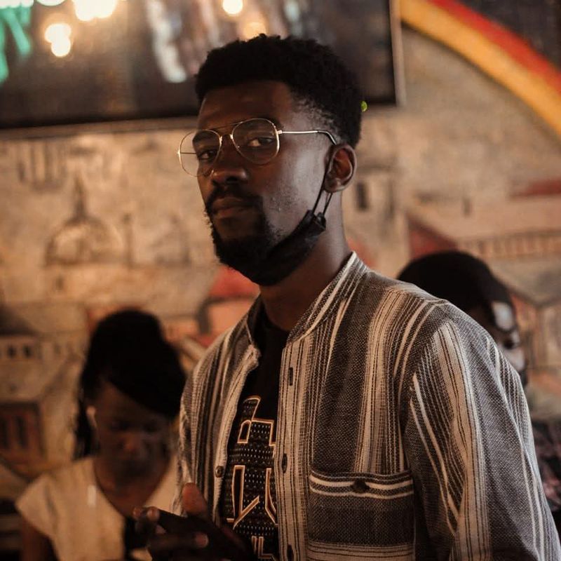 At a venue, glasses and striped shirt